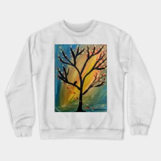 Black bird in the tree as the wind blows leaves off the tree Crewneck Sweatshirt